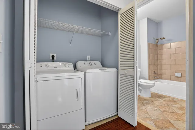 a view of bathroom with a washer and dryer