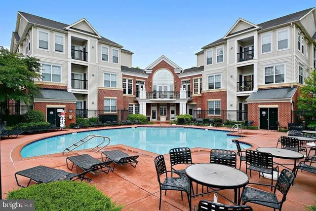 a front view of a house with swimming pool having outdoor seating
