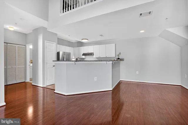 a view of a kitchen with wooden floor