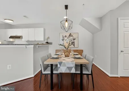 a view of a dining room with furniture wooden floor and chandelier