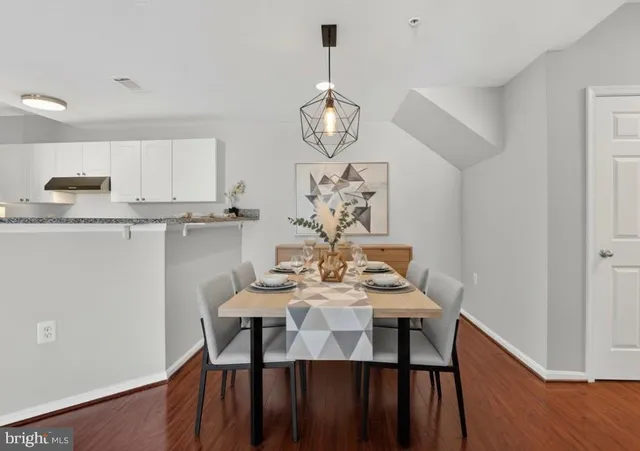 a view of a dining room with furniture wooden floor and chandelier