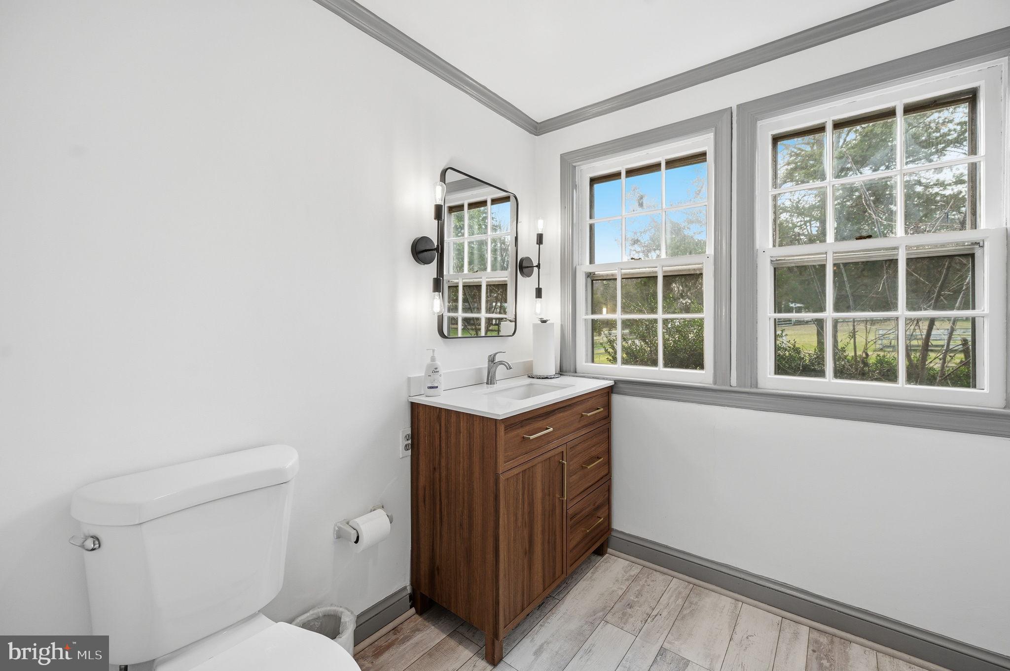 11641 Glen Road Potomac, MD 20854 - Photo 9 of 40 a bathroom with a sink toilet vanity and window
