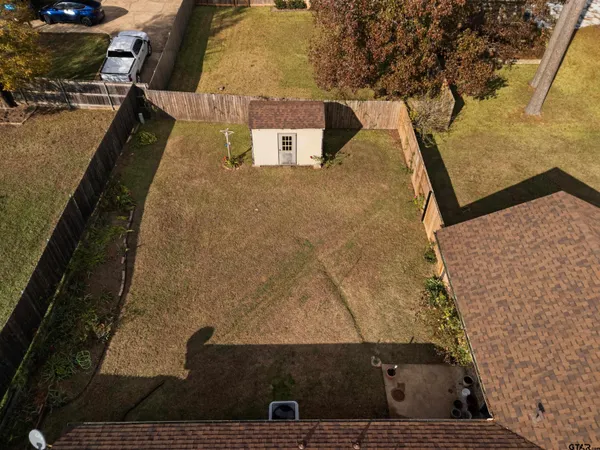 an aerial view of a houses with yard