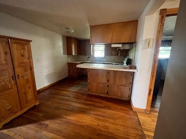 819 Ave N Sunray, TX 79086 - Photo 11 of 24 a kitchen with stainless steel appliances granite countertop a stove a sink and a refrigerator
