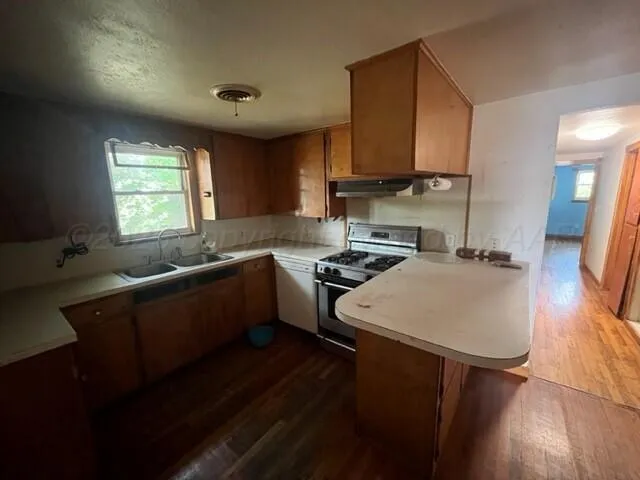 a kitchen that has a sink and a stove in it