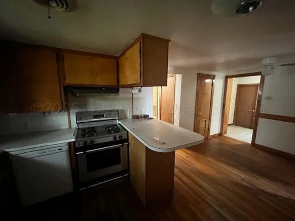 a kitchen with a sink stove and cabinets