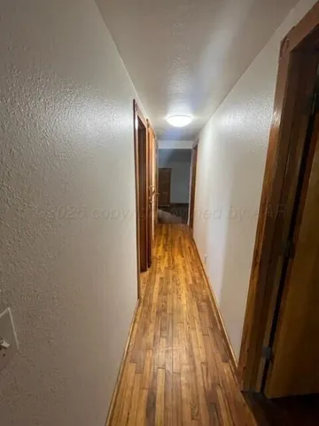 a view of hallway with wooden floor