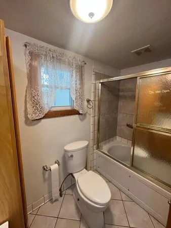a white toilet sitting next to a bathroom sink