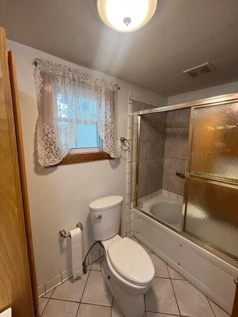 819 Ave N Sunray, TX 79086 - Photo 17 of 24 a white toilet sitting next to a bathroom sink
