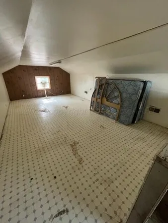 a bedroom with a bed and a night stand