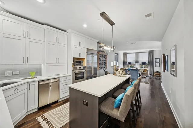 a kitchen with white cabinets and center island