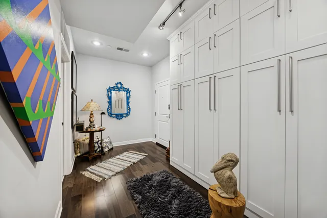 a bedroom with a bed and a painting on the wall