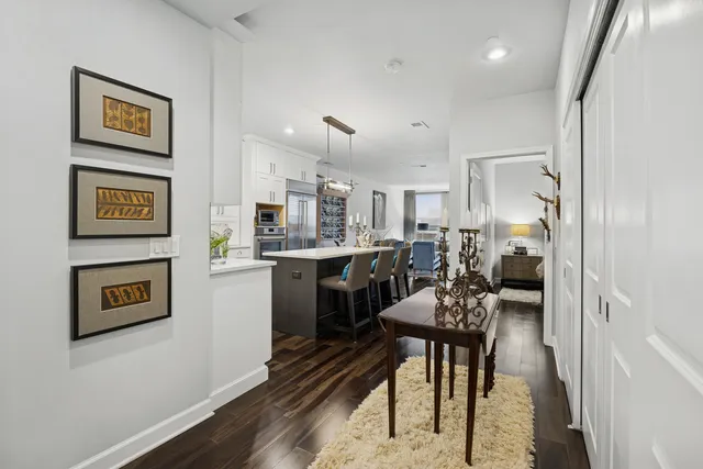 a very nice looking dining room with kitchen island a stove a table and chairs