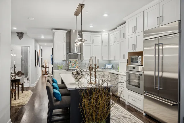 a large kitchen with a table and chairs