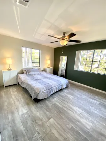 a bedroom with a large bed and a chandelier