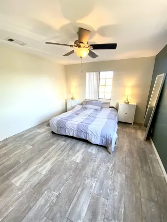 a bedroom with a bed and ceiling fan