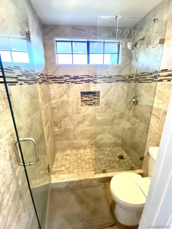 a bathroom with toilet sink and shower