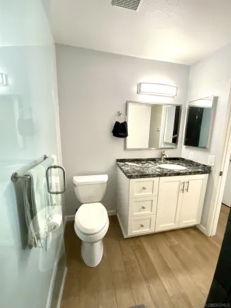 a bathroom with a toilet sink and mirror