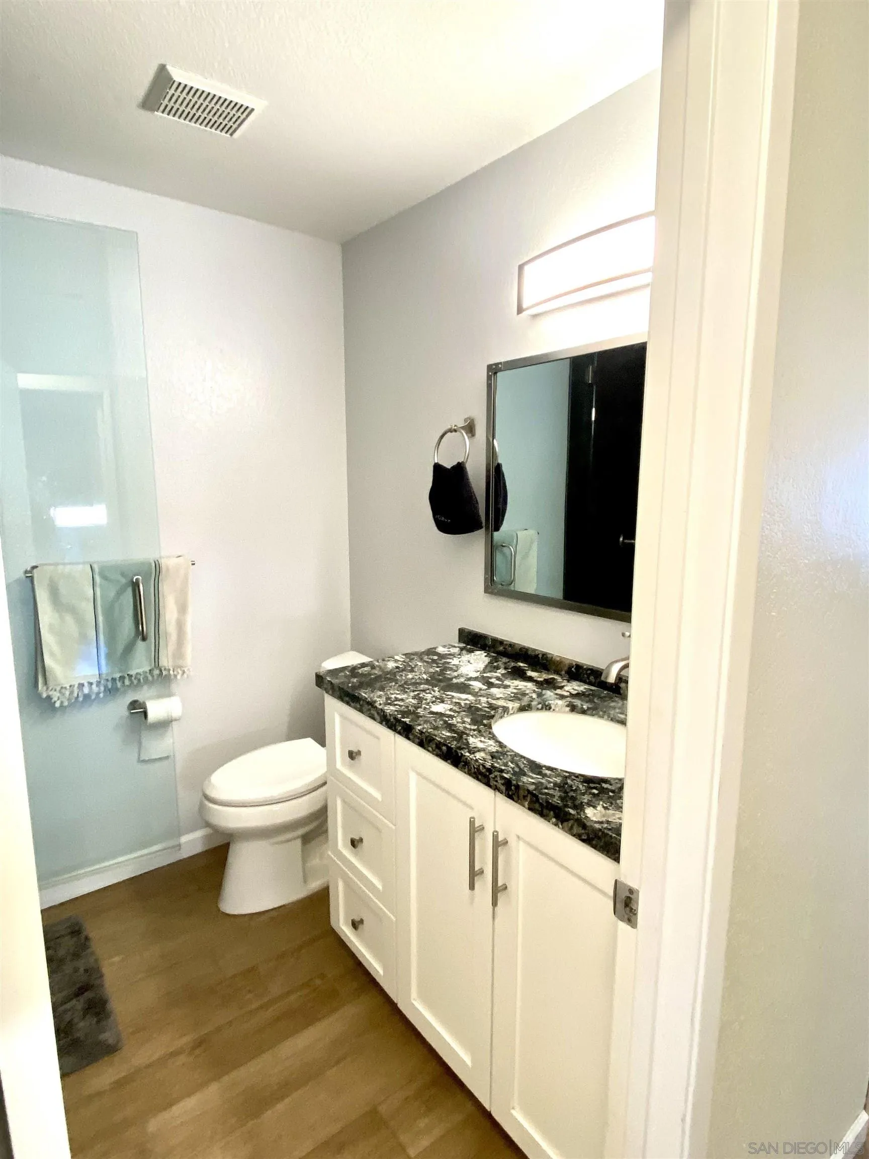 8834 Tamberly Lane, Unit D Santee, CA 92071 - Photo 20 of 28 a bathroom with a granite countertop toilet and sink