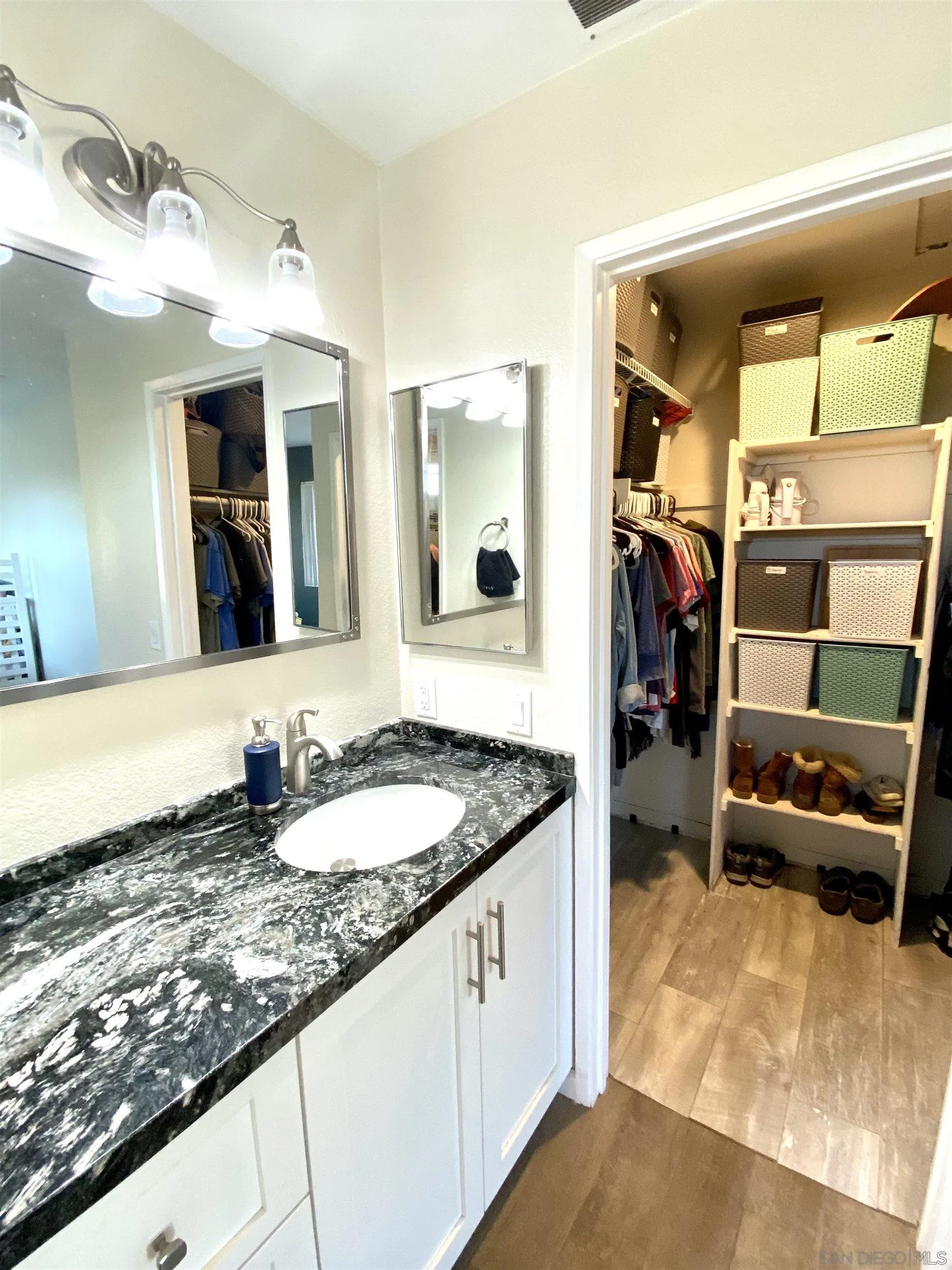 8834 Tamberly Lane, Unit D Santee, CA 92071 - Photo 23 of 28 a en suite bathroom with a granite countertop tub and a large mirror