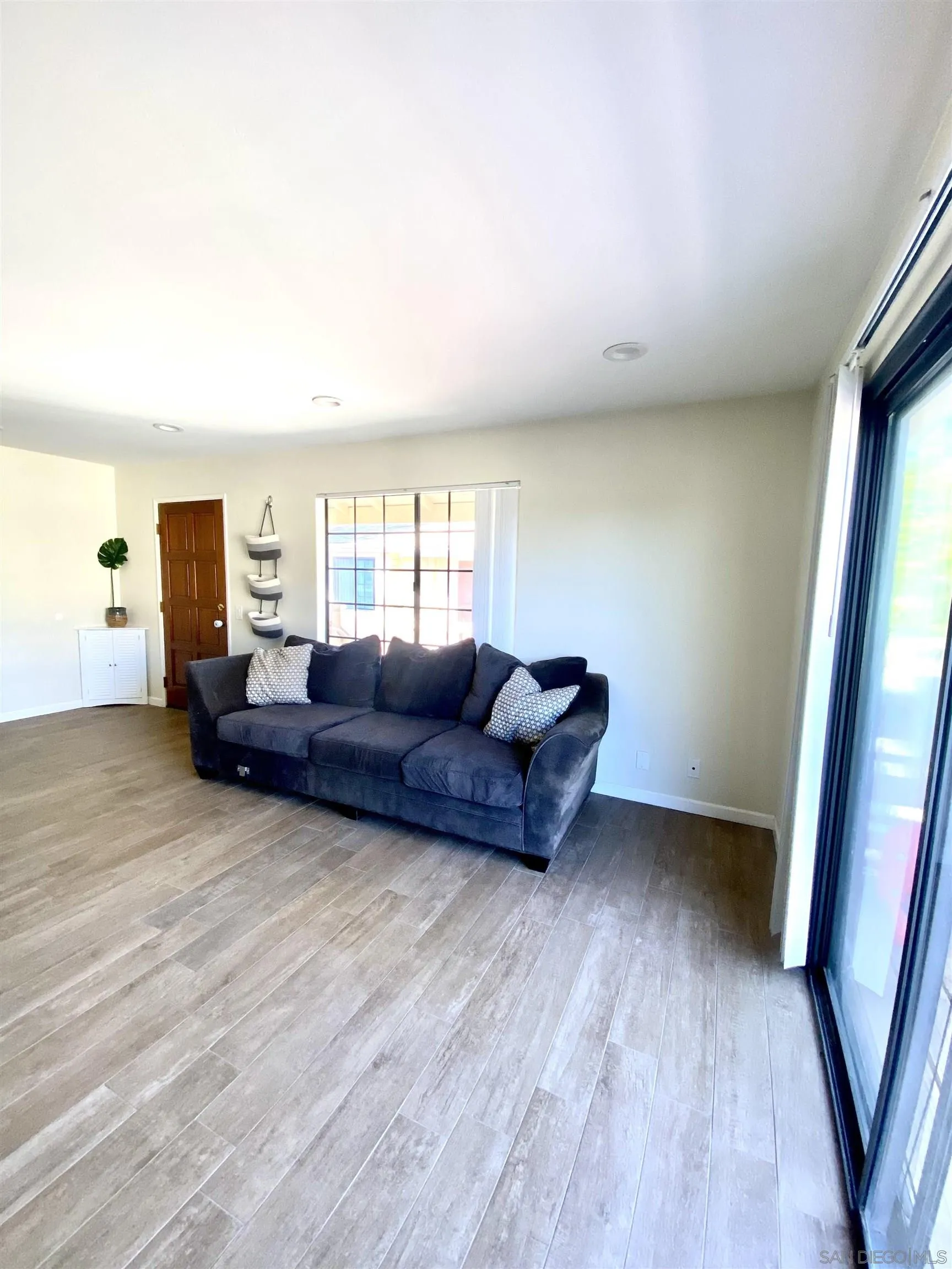 8834 Tamberly Lane, Unit D Santee, CA 92071 - Photo 3 of 28 a living room with furniture and a flat screen tv