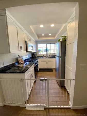 a kitchen with stainless steel appliances granite countertop a stove and a refrigerator