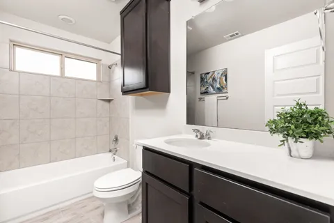 a bathroom with a sink a toilet and a bathtub