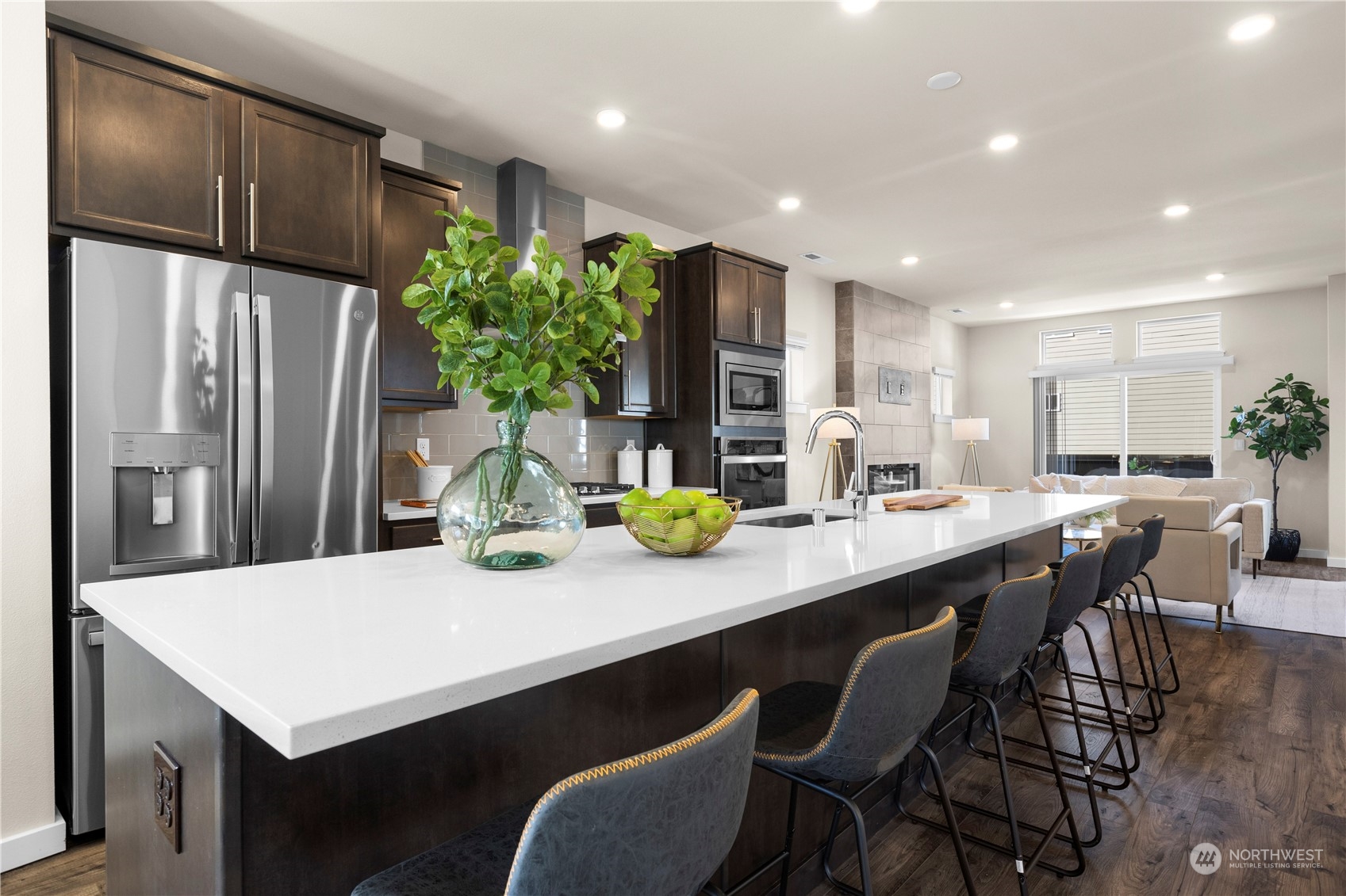20803 3rd Drive Southeast Bothell, WA 98012 - Photo 4 of 30 a kitchen with stainless steel appliances a dining table chairs and refrigerator