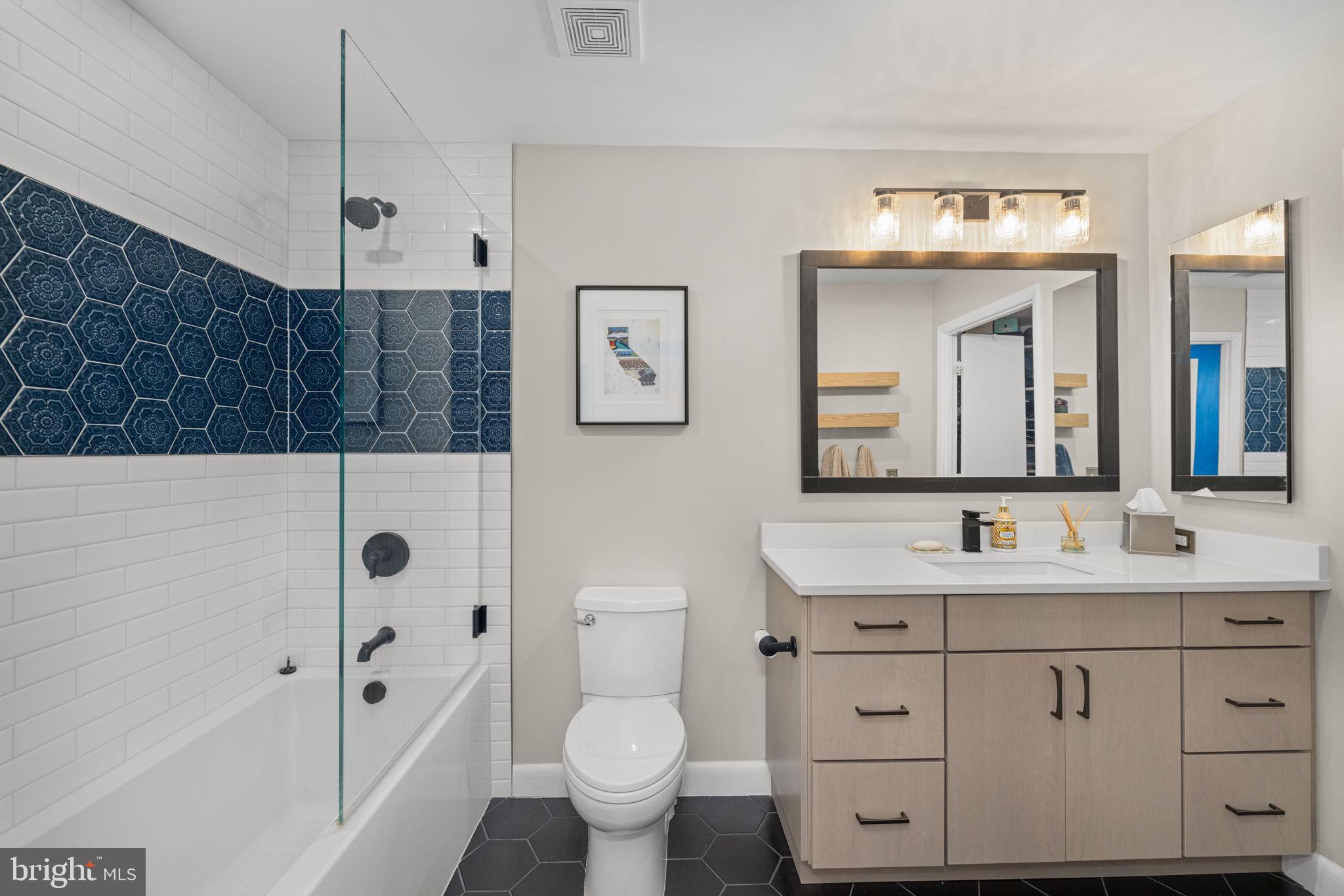 400 Massachusetts Avenue Northwest, Unit 1011 Washington, DC 20001 - Photo 16 of 31 a bathroom with a sink toilet vanity and shower