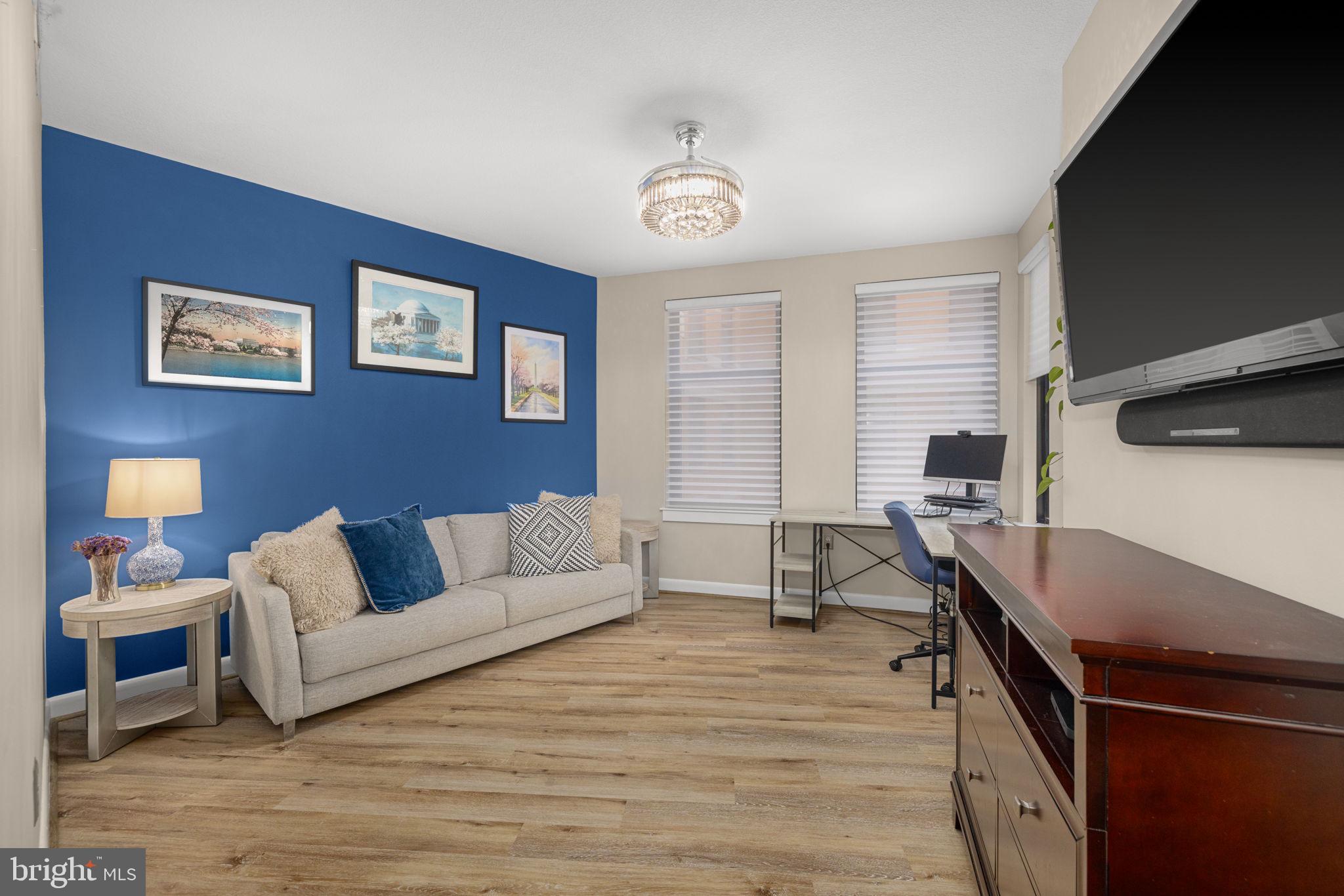 400 Massachusetts Avenue Northwest, Unit 1011 Washington, DC 20001 - Photo 18 of 31 a living room with furniture and a wooden floor