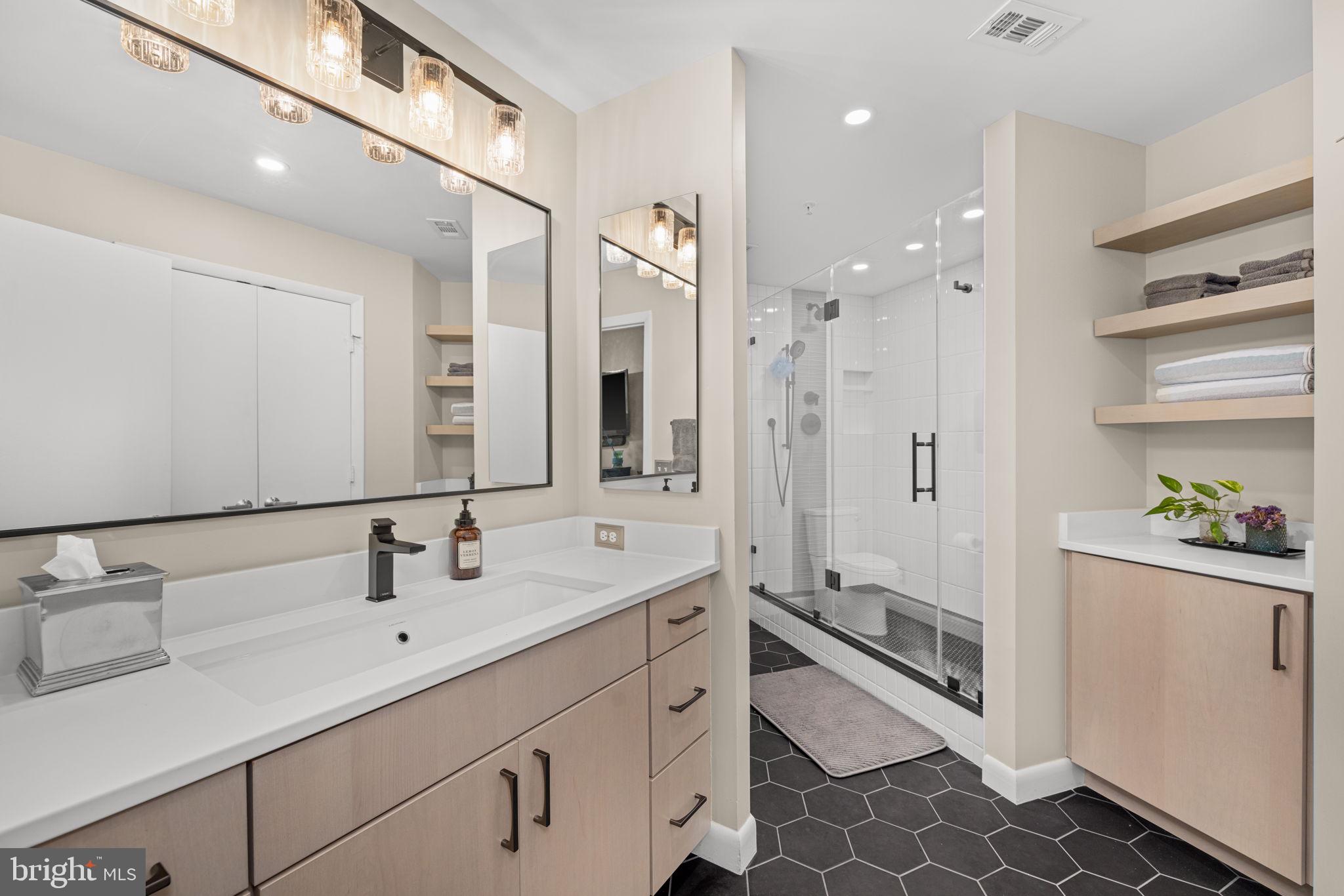 400 Massachusetts Avenue Northwest, Unit 1011 Washington, DC 20001 - Photo 19 of 31 a bathroom with a double vanity sink mirror and shower