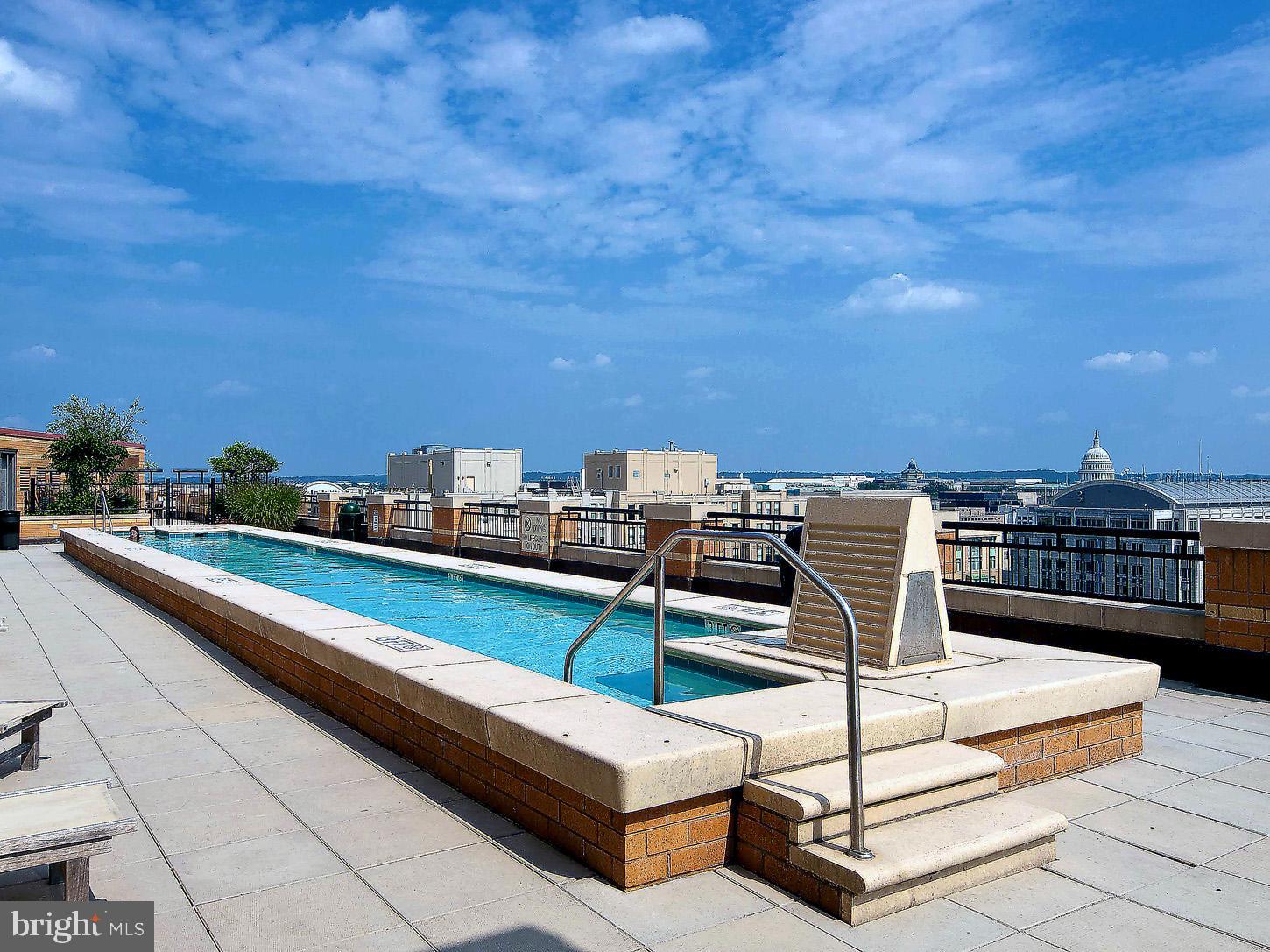 400 Massachusetts Avenue Northwest, Unit 1011 Washington, DC 20001 - Photo 27 of 31 a roof deck with a table and chairs
