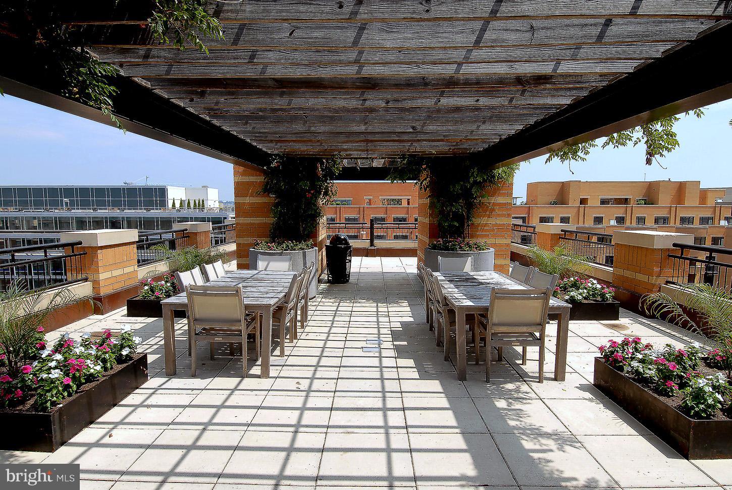 400 Massachusetts Avenue Northwest, Unit 1011 Washington, DC 20001 - Photo 28 of 31 a outdoor space with lots of fruit on table and chairs