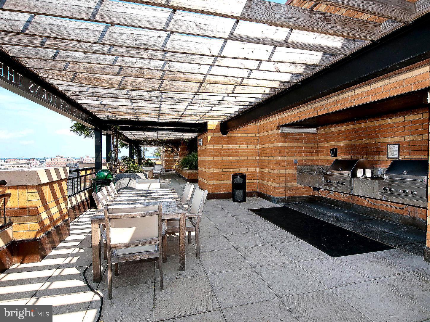 400 Massachusetts Avenue Northwest, Unit 1011 Washington, DC 20001 - Photo 29 of 31 a view of a patio with table and chairs with wooden floor
