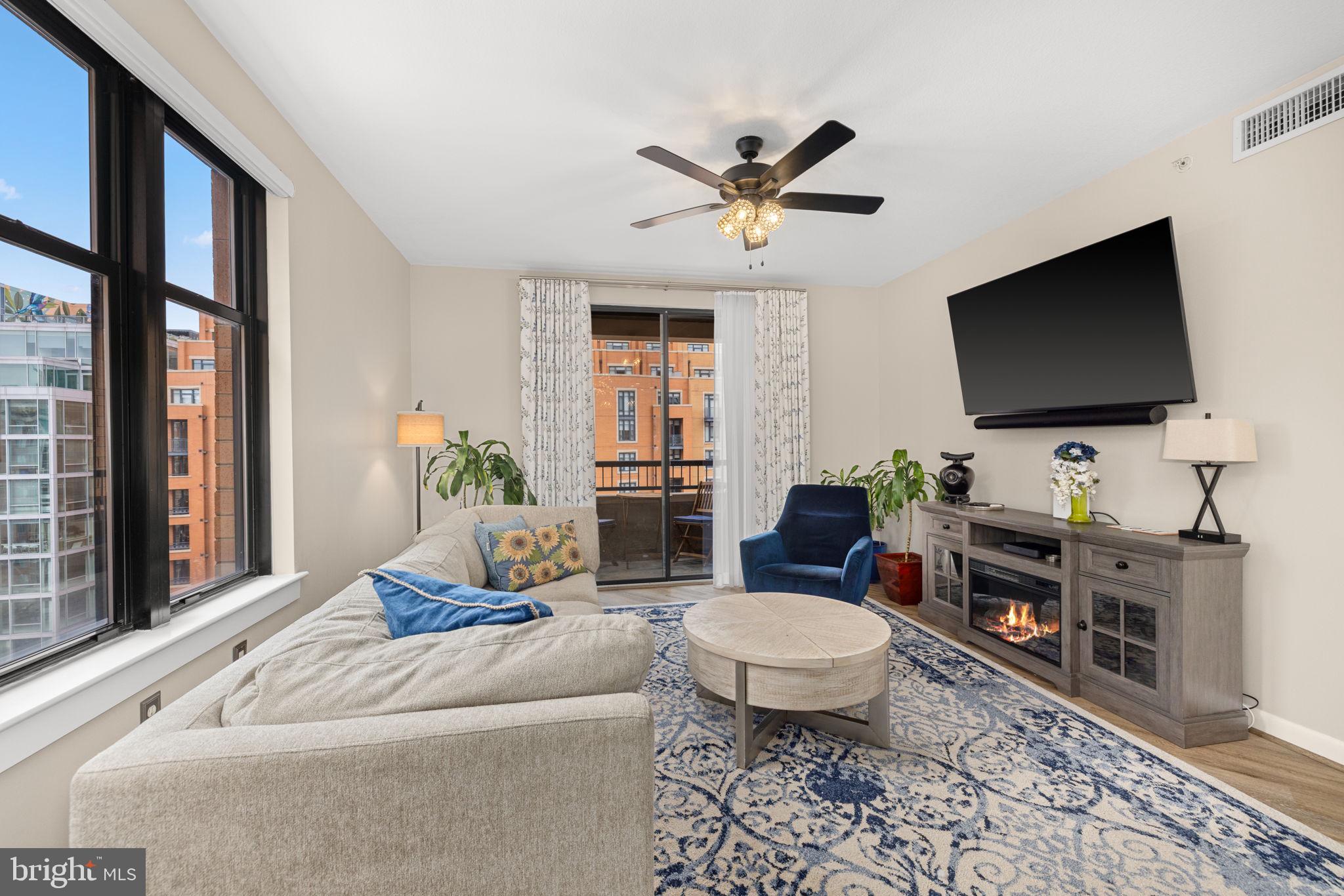 400 Massachusetts Avenue Northwest, Unit 1011 Washington, DC 20001 - Photo 3 of 31 a living room with furniture and a flat screen tv