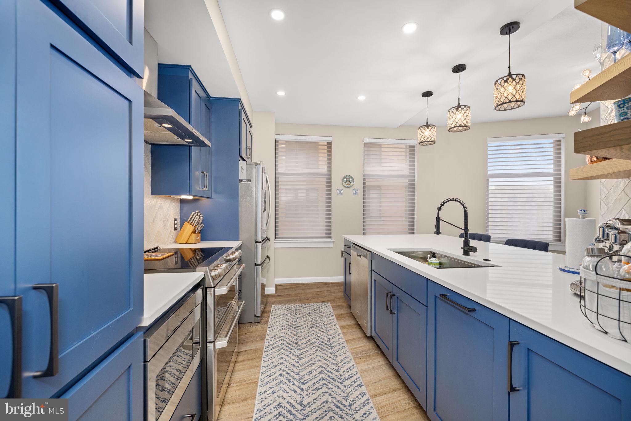 400 Massachusetts Avenue Northwest, Unit 1011 Washington, DC 20001 - Photo 6 of 31 a kitchen with stainless steel appliances a sink stove and cabinets