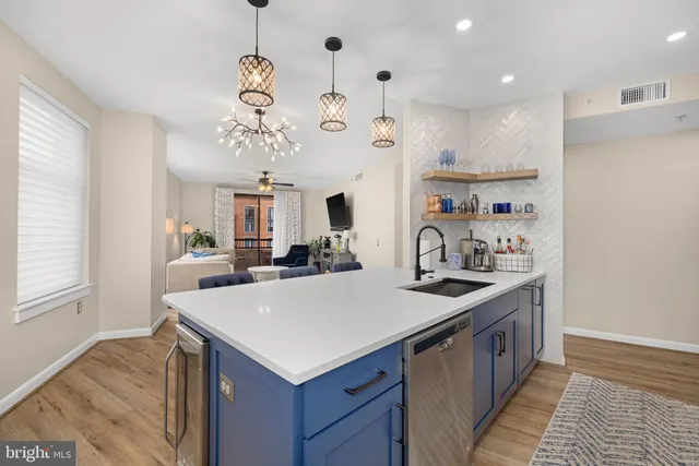a kitchen with a sink a stove and chairs