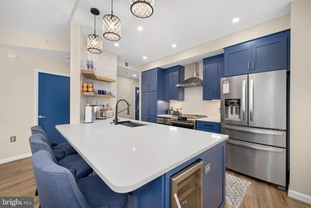 a kitchen with refrigerator cabinets and wooden floor