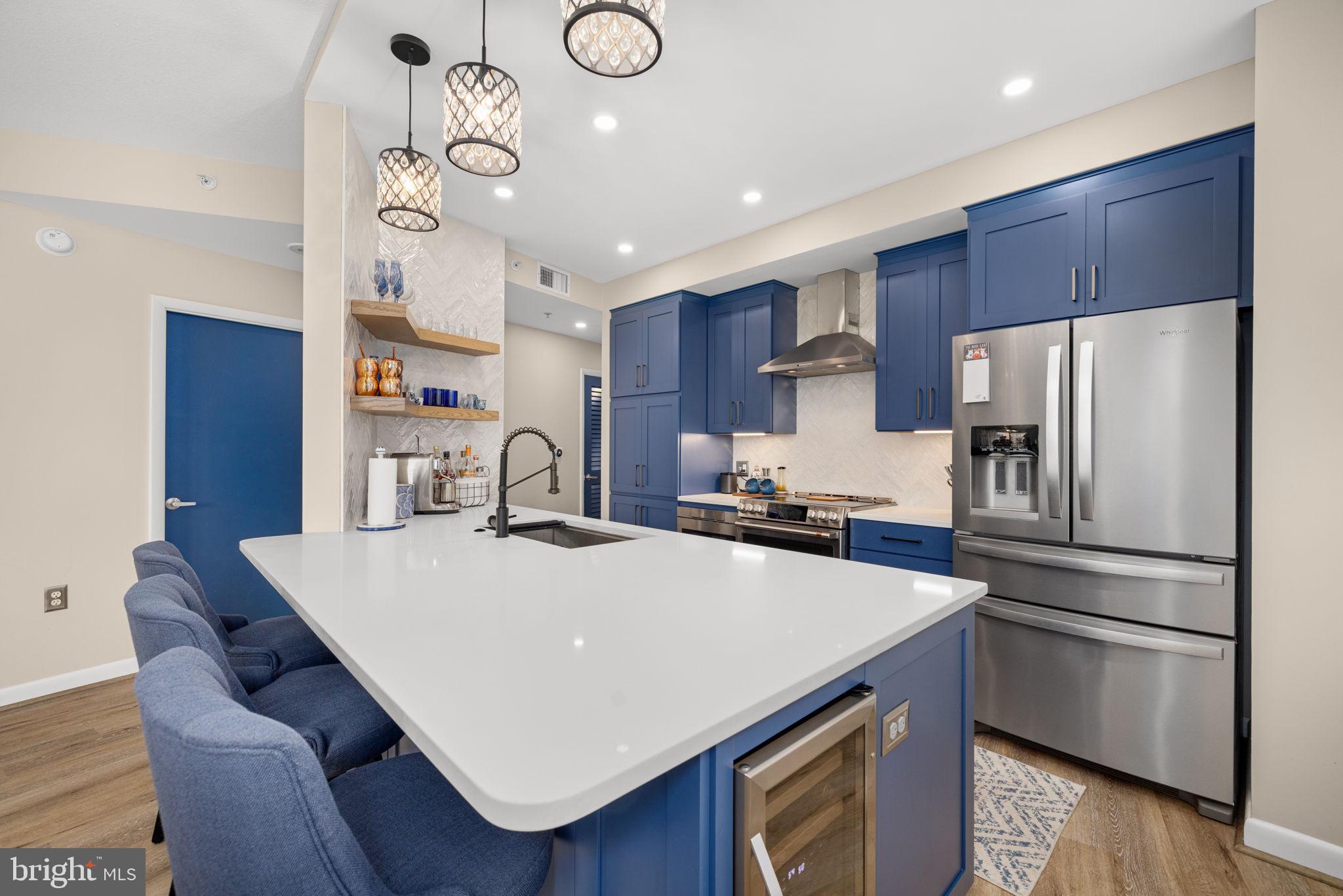 400 Massachusetts Avenue Northwest, Unit 1011 Washington, DC 20001 - Photo 8 of 31 a kitchen with refrigerator cabinets and wooden floor
