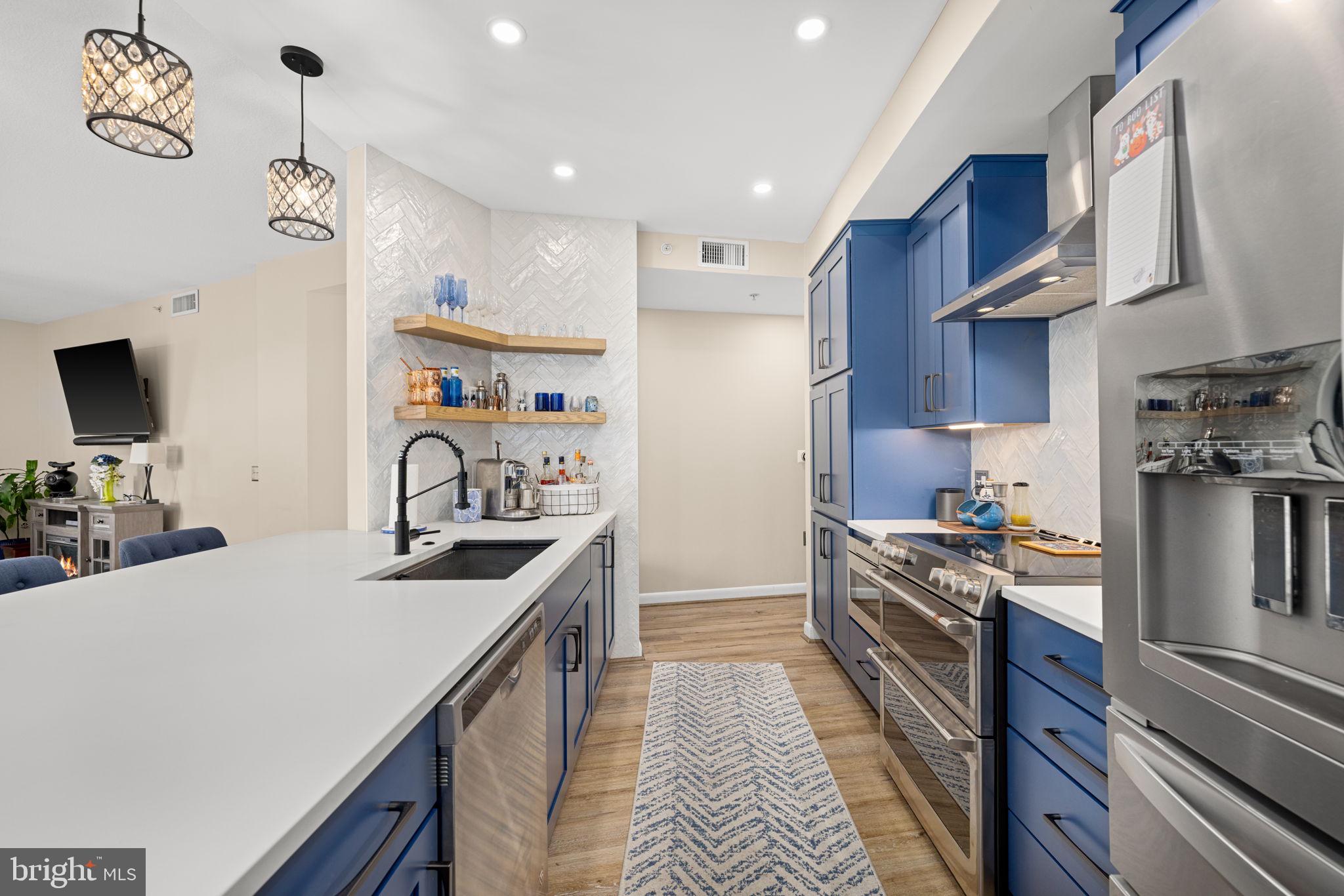 400 Massachusetts Avenue Northwest, Unit 1011 Washington, DC 20001 - Photo 9 of 31 a kitchen with stainless steel appliances granite countertop a sink stove and refrigerator