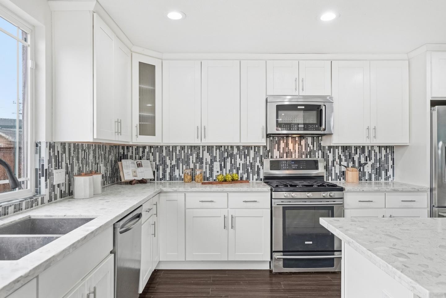 36045 Haley Street Newark, CA 94560 - Photo 13 of 38 a kitchen with granite countertop a sink cabinets and stainless steel appliances