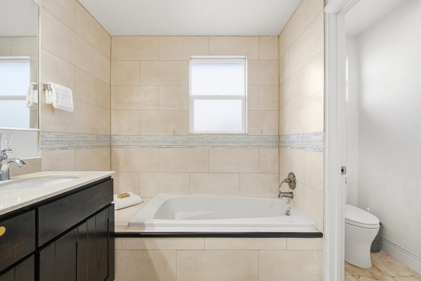 36045 Haley Street Newark, CA 94560 - Photo 17 of 38 a bath tub sitting next to a white toilet