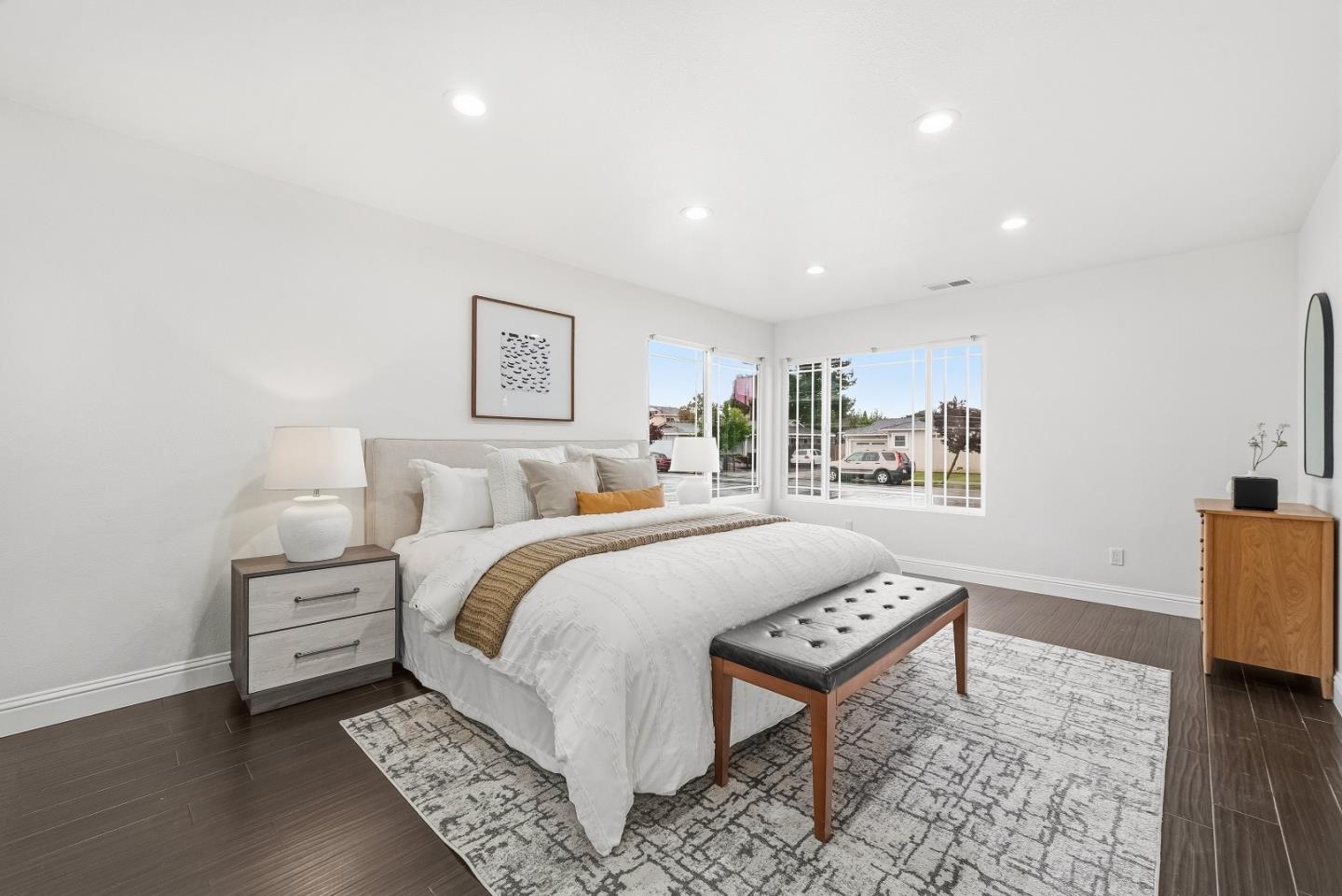 36045 Haley Street Newark, CA 94560 - Photo 18 of 38 a bed room with a bed and a night stand