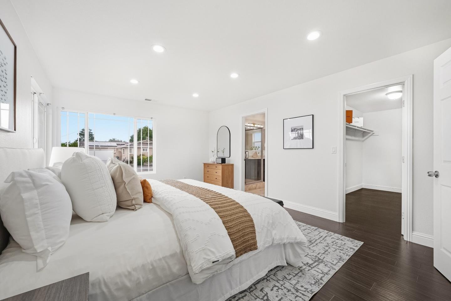 36045 Haley Street Newark, CA 94560 - Photo 19 of 38 a bedroom with a large bed and wooden floor