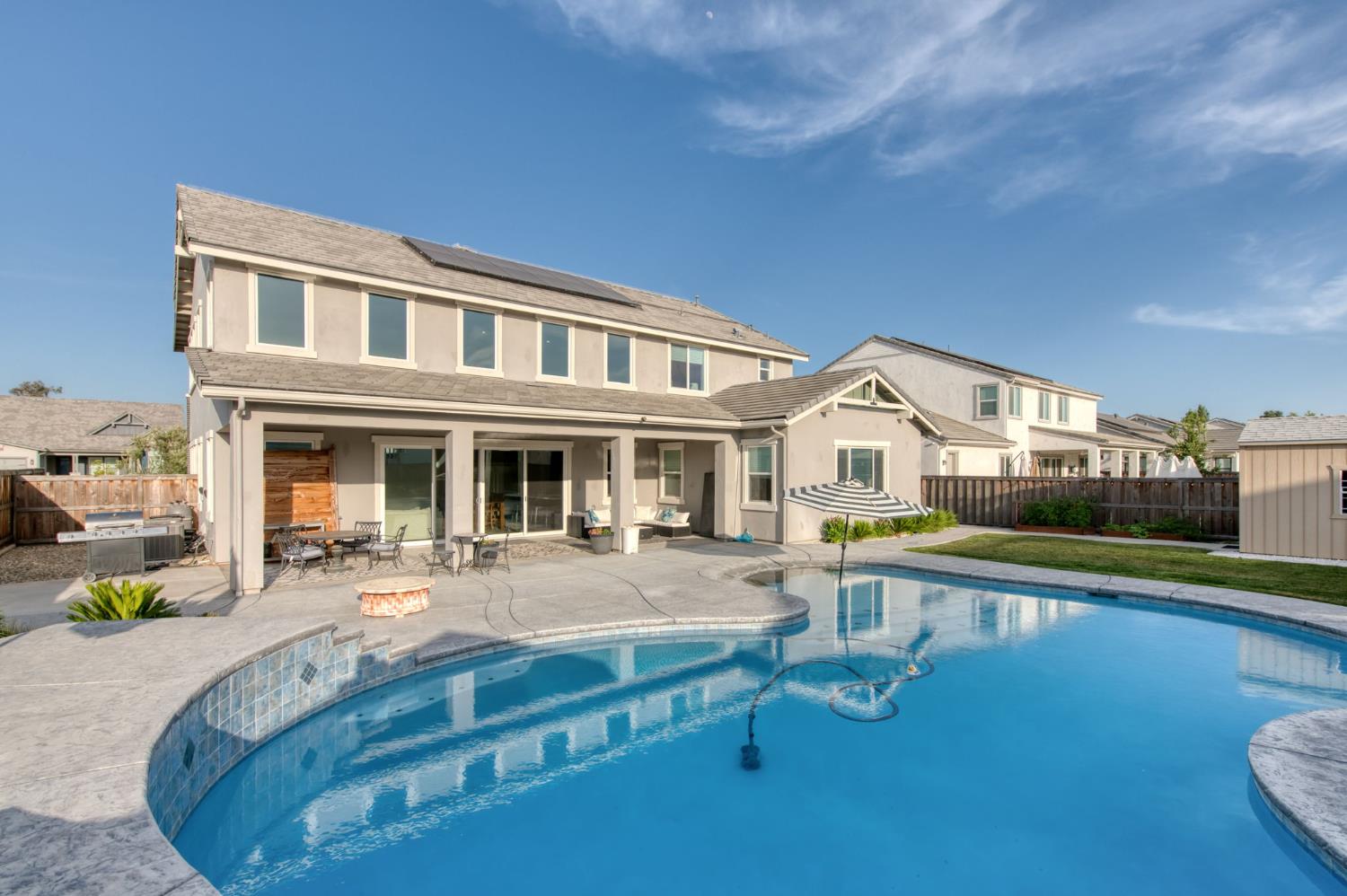 1736 North Renn Avenue Clovis, CA 93619 - Photo 41 of 66 a front view of a house with swimming pool having outdoor seating