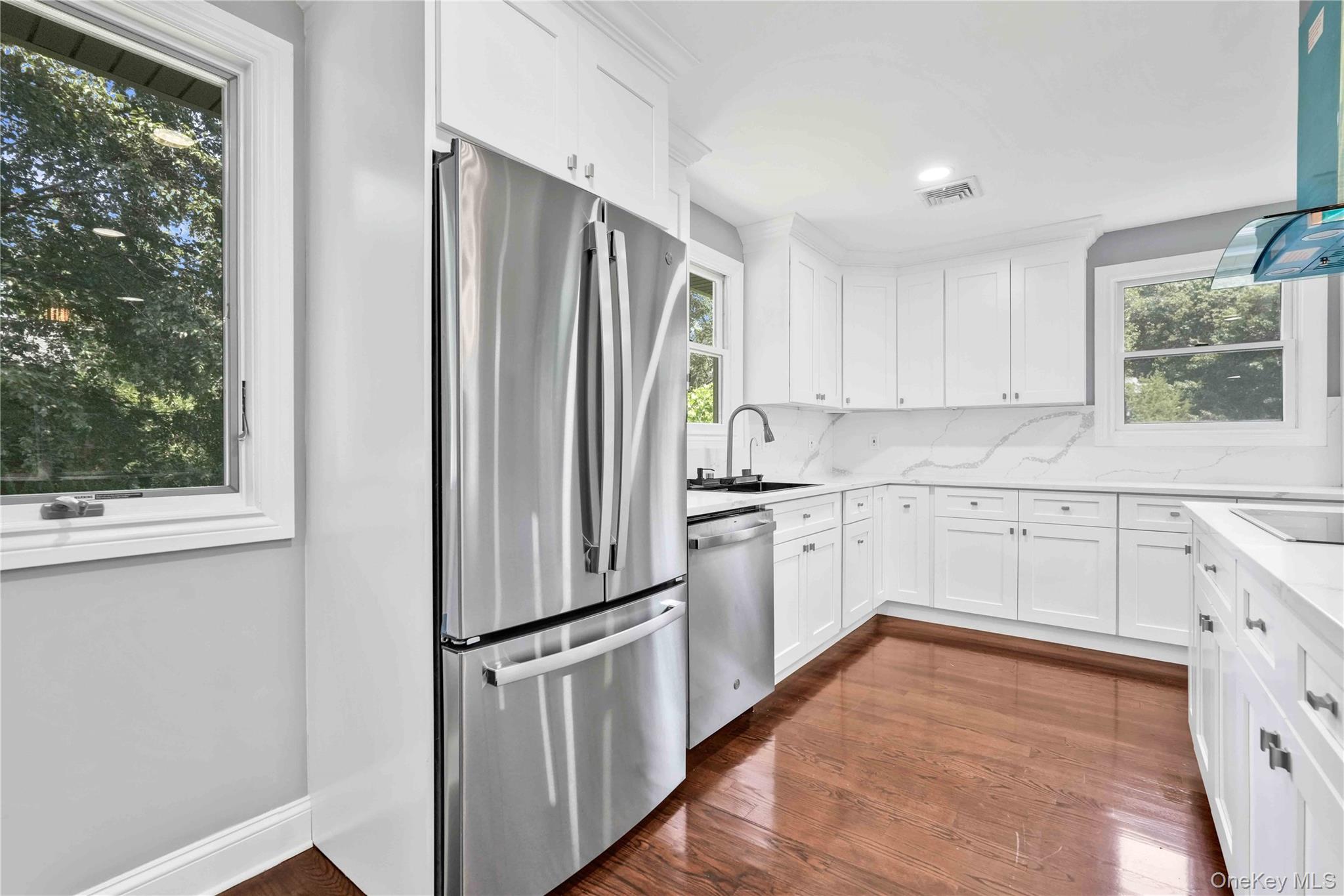 45 Forest Drive Centerport, NY 11721 - Photo 7 of 41 a kitchen with white cabinets and window