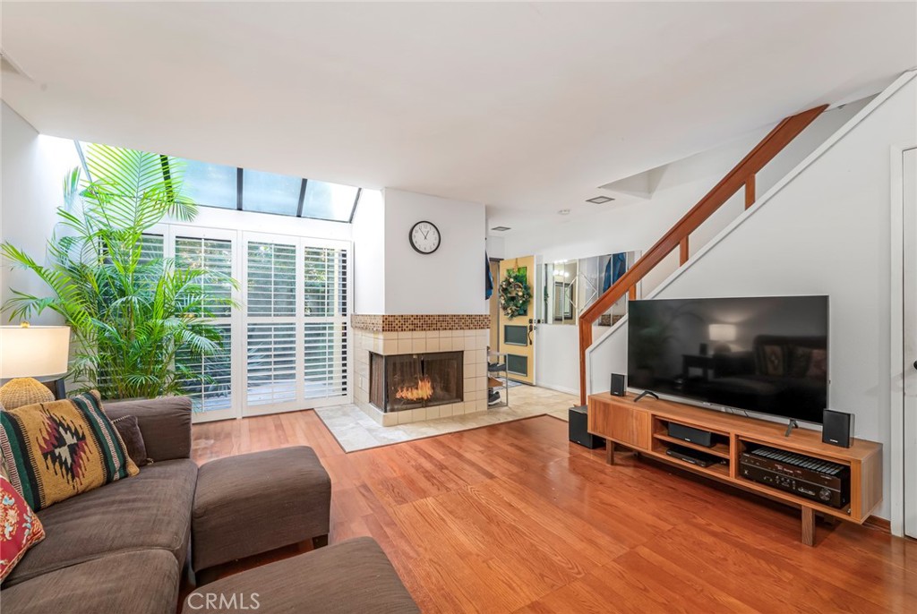 a living room with furniture flat screen tv and a fireplace