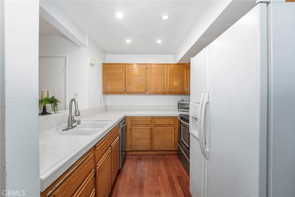 25712 Le Parc, Unit 48 Lake Forest, CA 92630 - Photo 12 of 30 a kitchen with a sink and a refrigerator