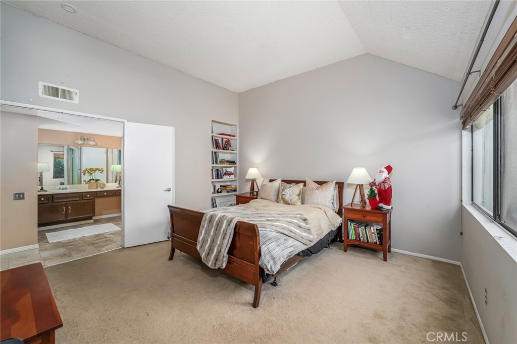 25712 Le Parc, Unit 48 Lake Forest, CA 92630 - Photo 14 of 30 a spacious bedroom with a bed and a couch