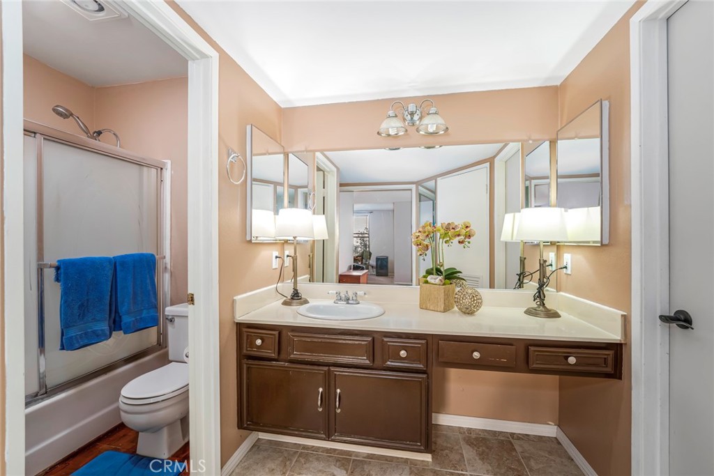 25712 Le Parc, Unit 48 Lake Forest, CA 92630 - Photo 16 of 30 a bathroom with a sink vanity granite toilet and a mirror